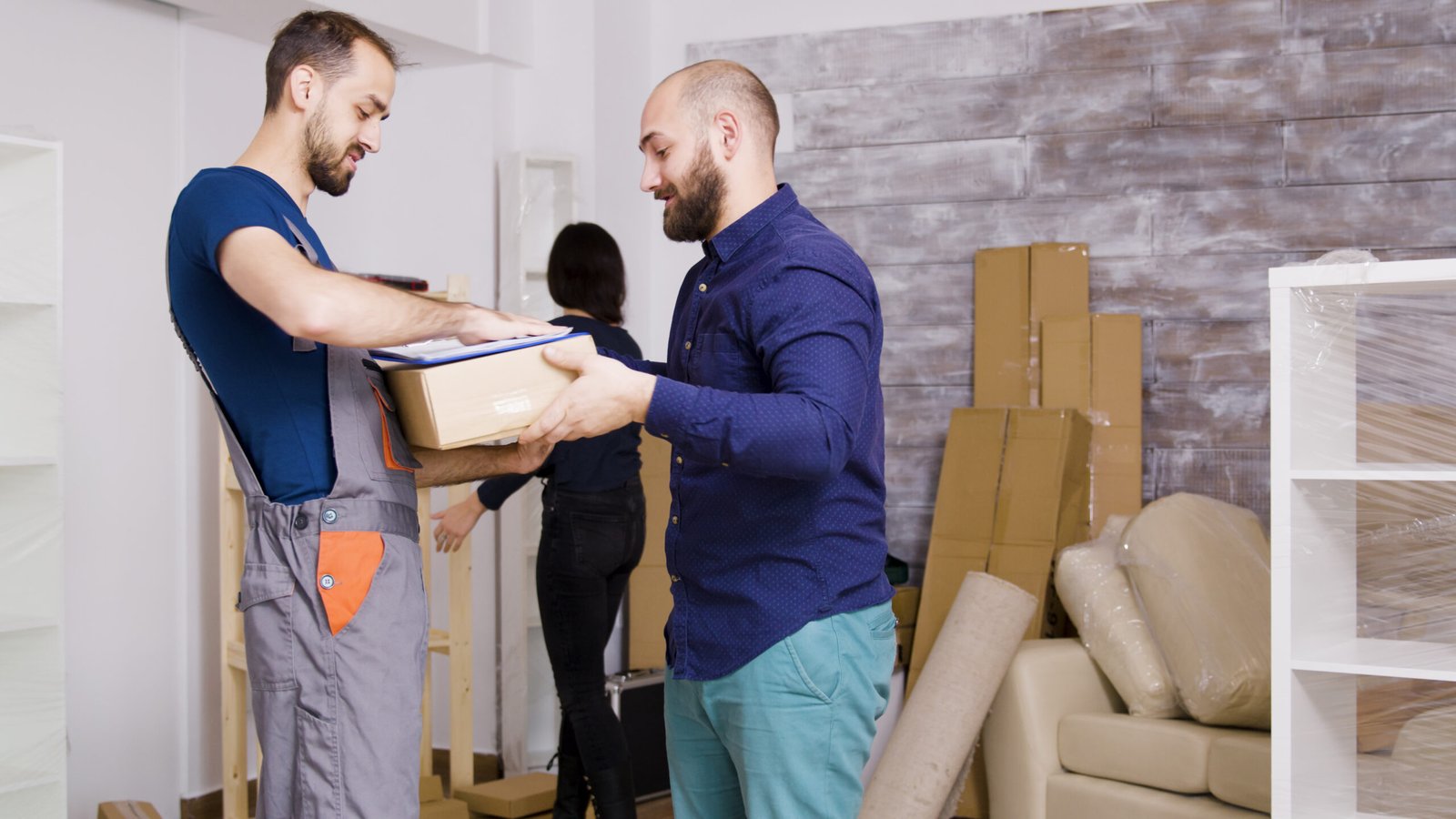 man from delivery service arriving with boxes and documents to be signed