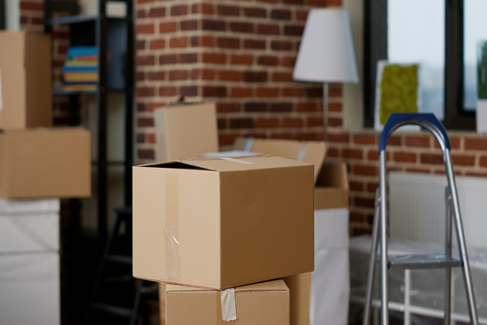 About Us stacks of cardboard boxes in empty real estate property